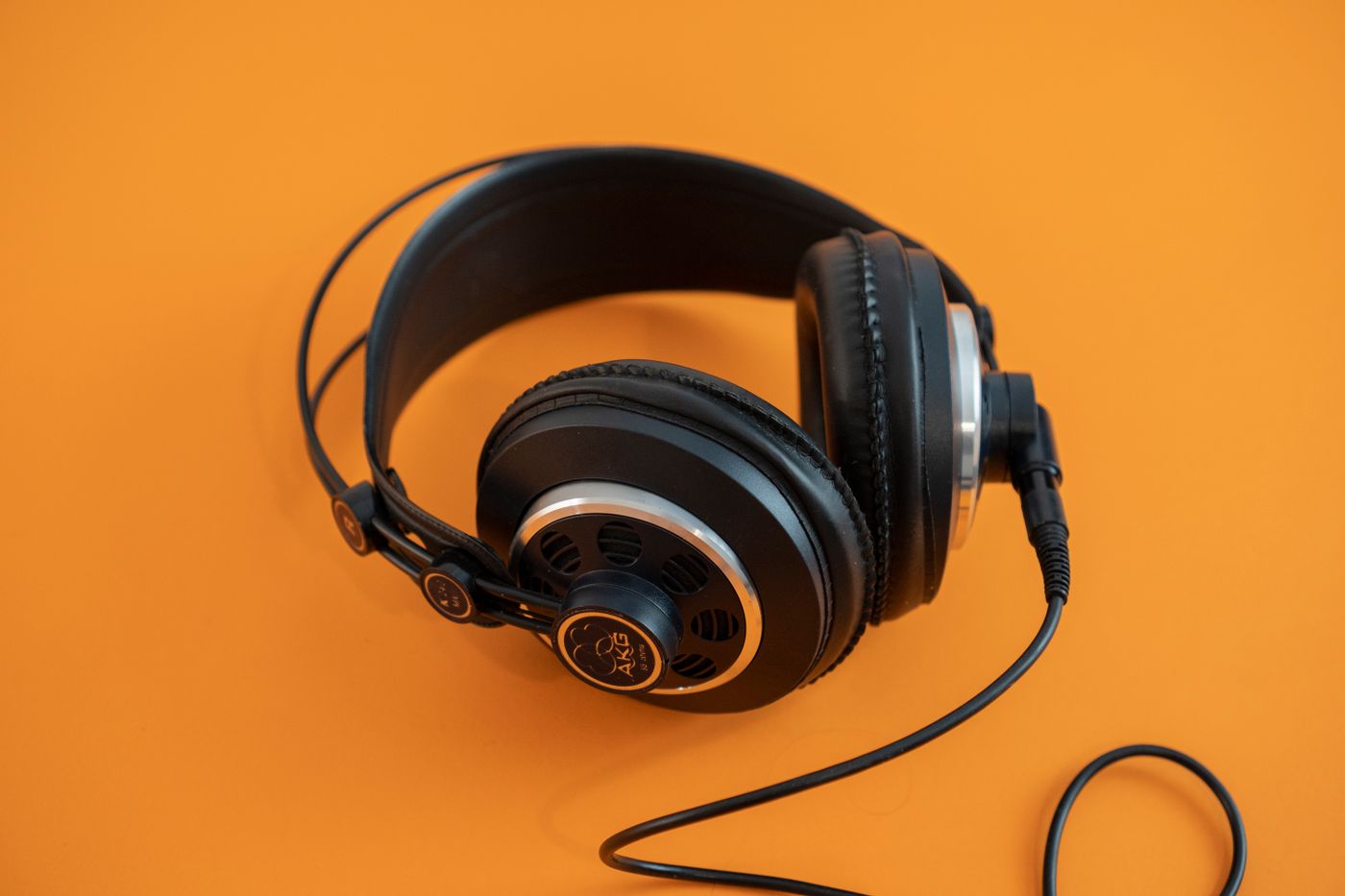 Over-ear headphones on an orange background