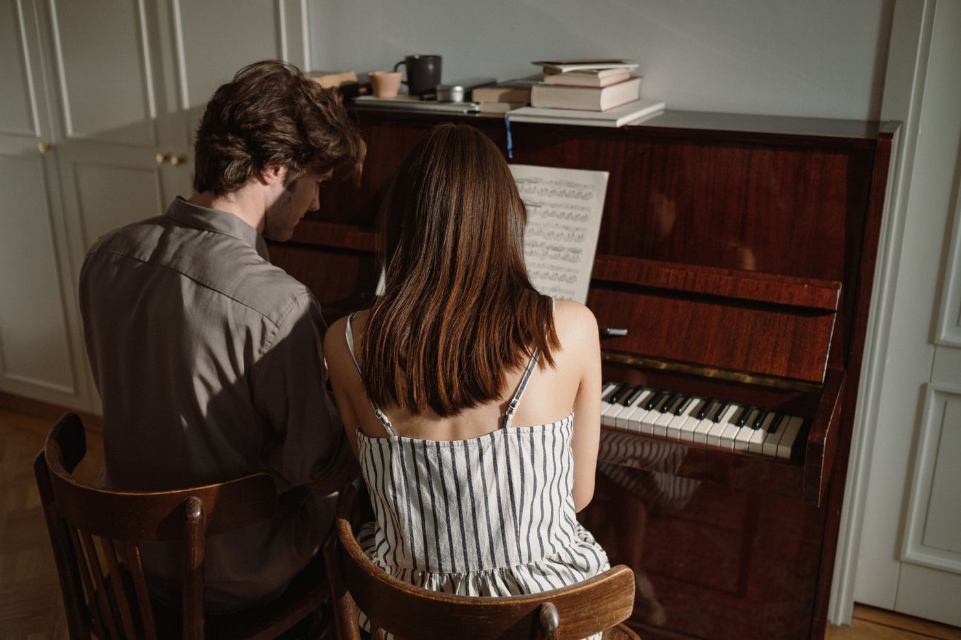 Two musicians practicing together at a piano