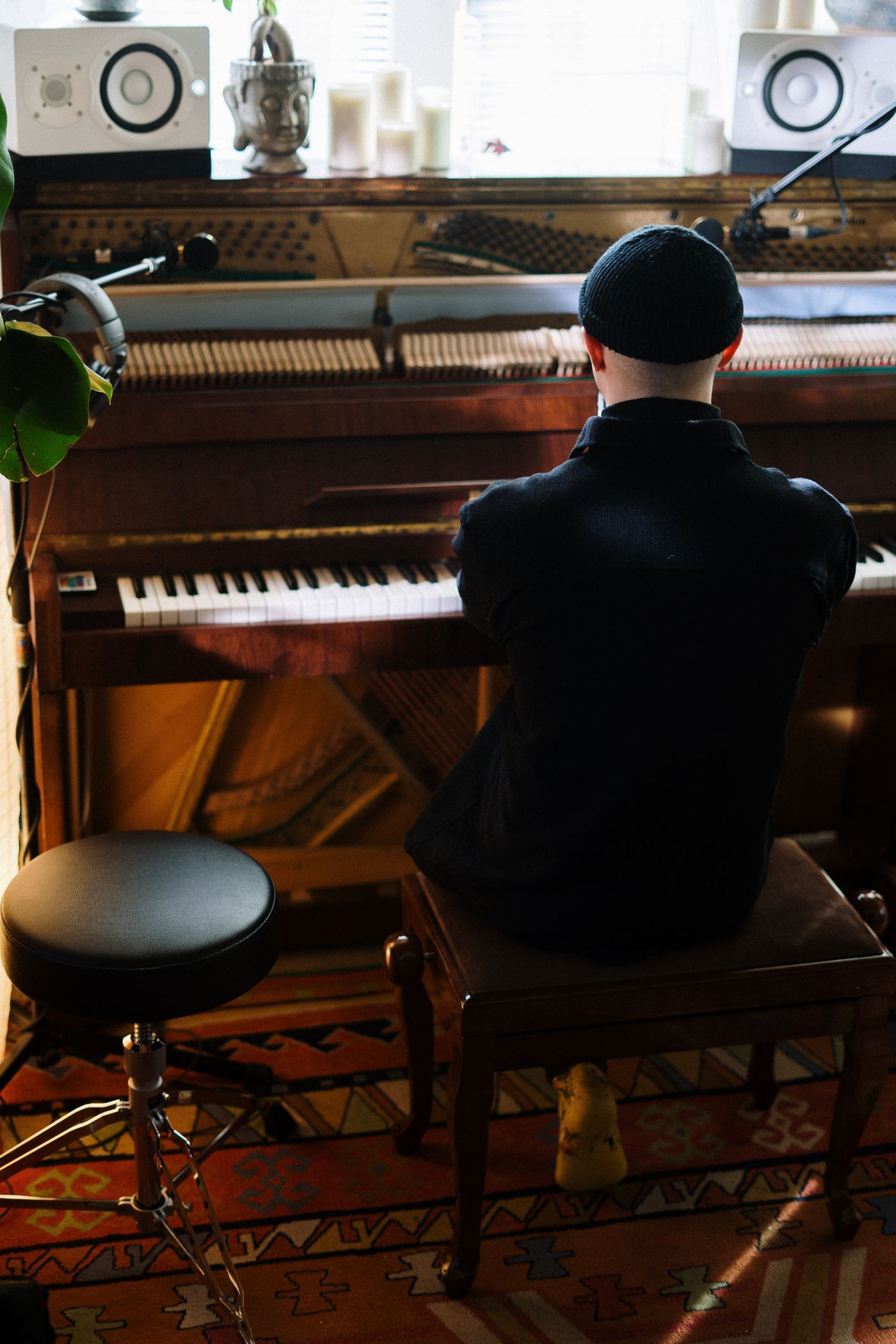 A musician playing piano in a home music workspace