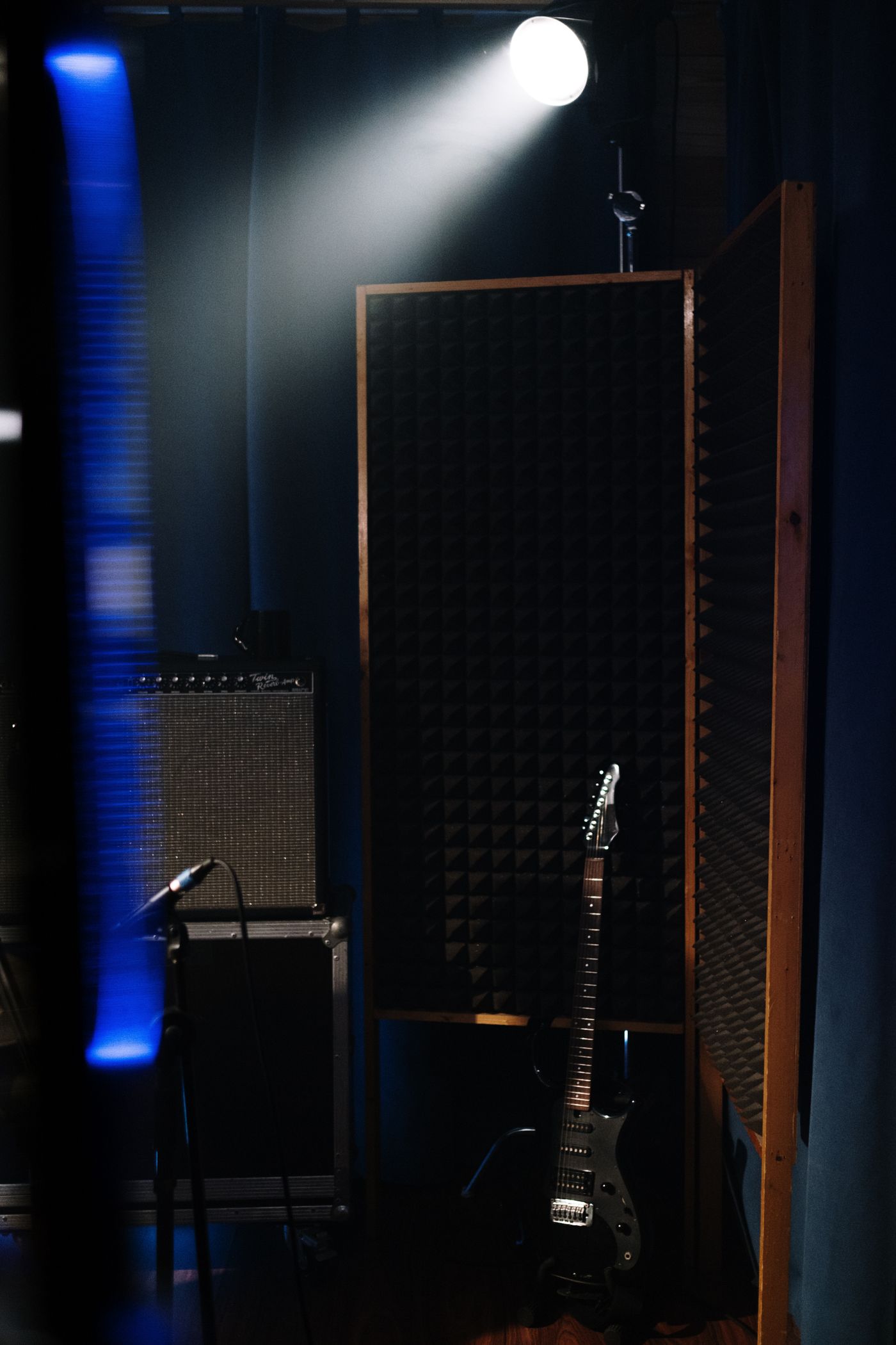 An electric guitar beside recording equipment