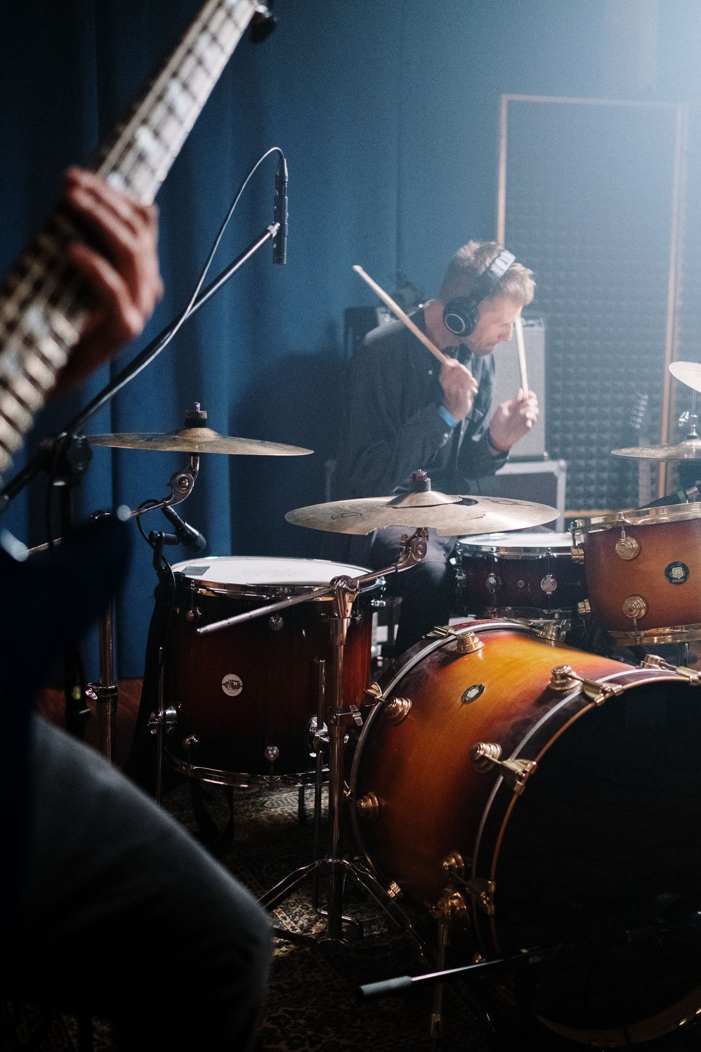 A guitarist and drummer rehearsing together