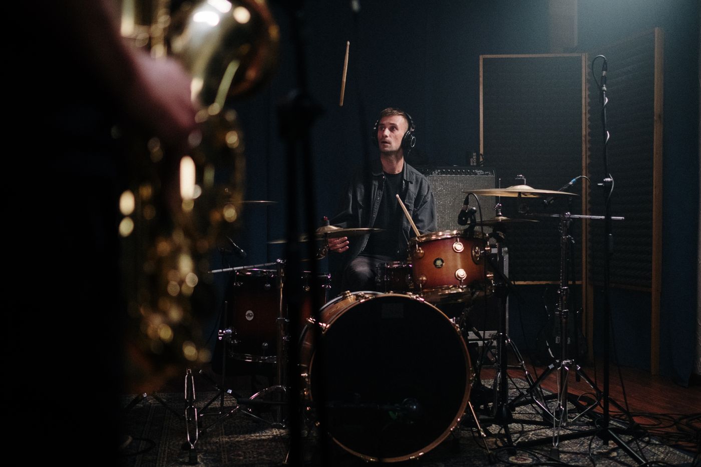 A drummer recording a performance in a studio