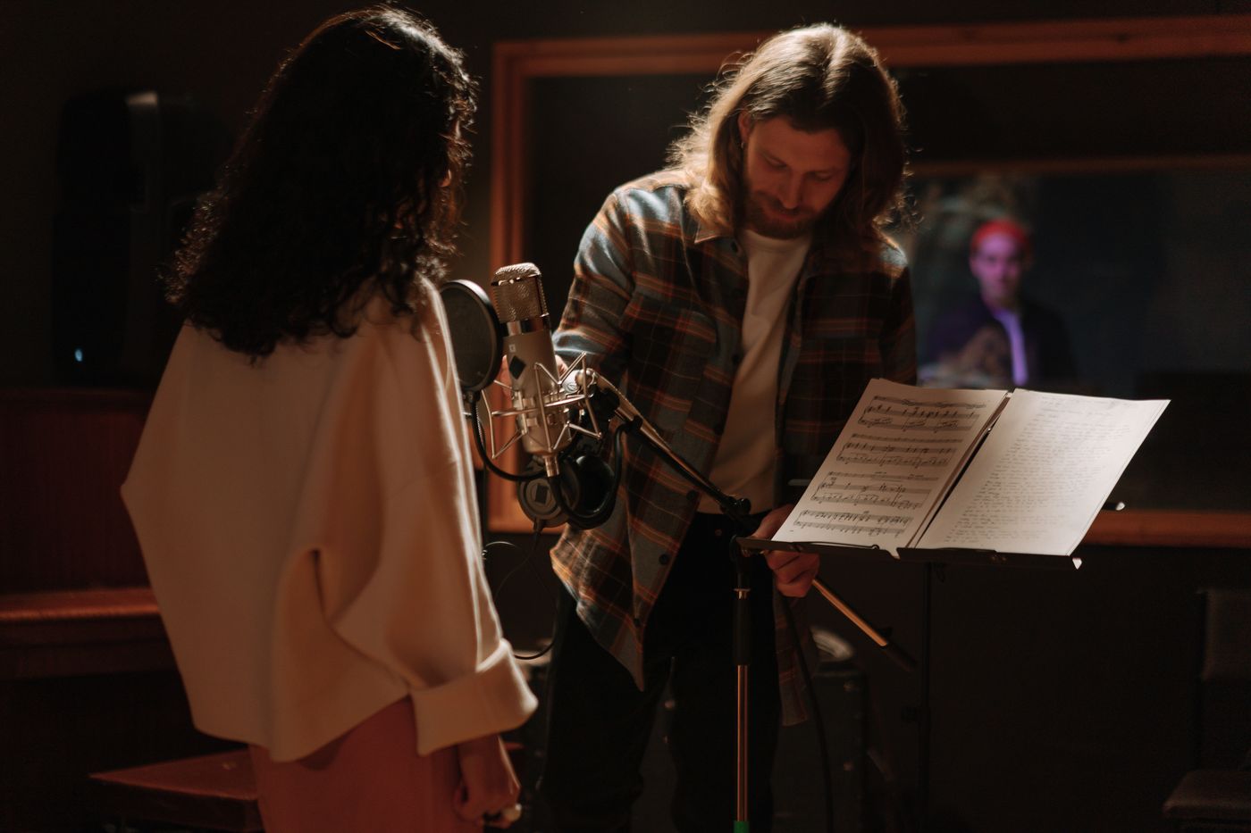 Musicians working together beside a recording microphone