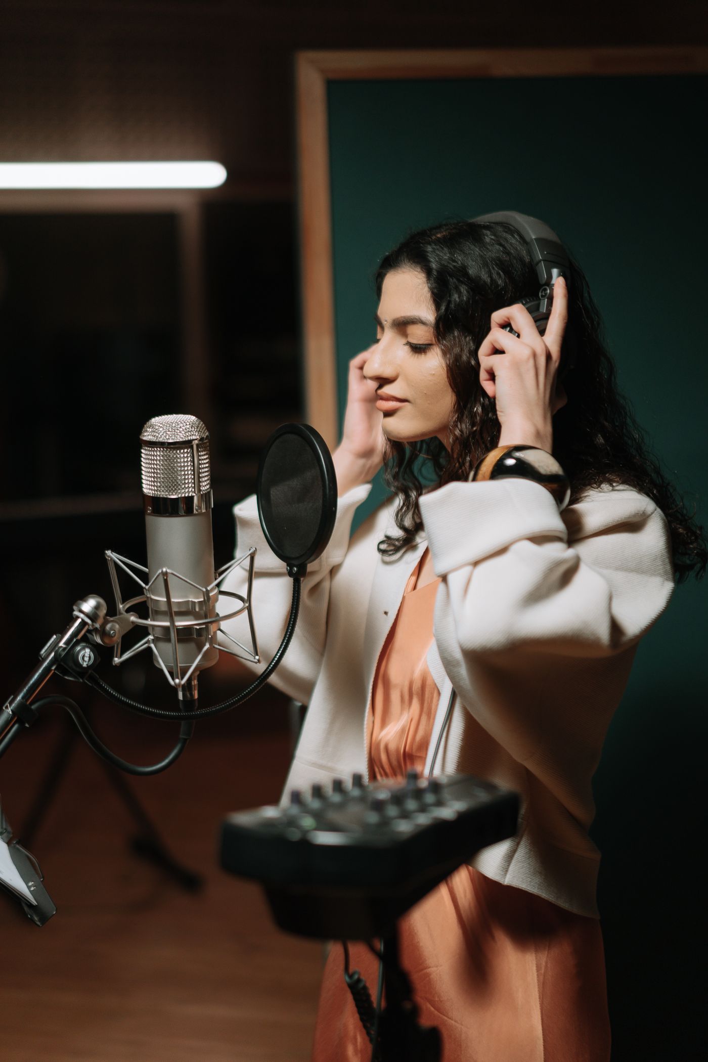 A singer concentrating on a take in a studio