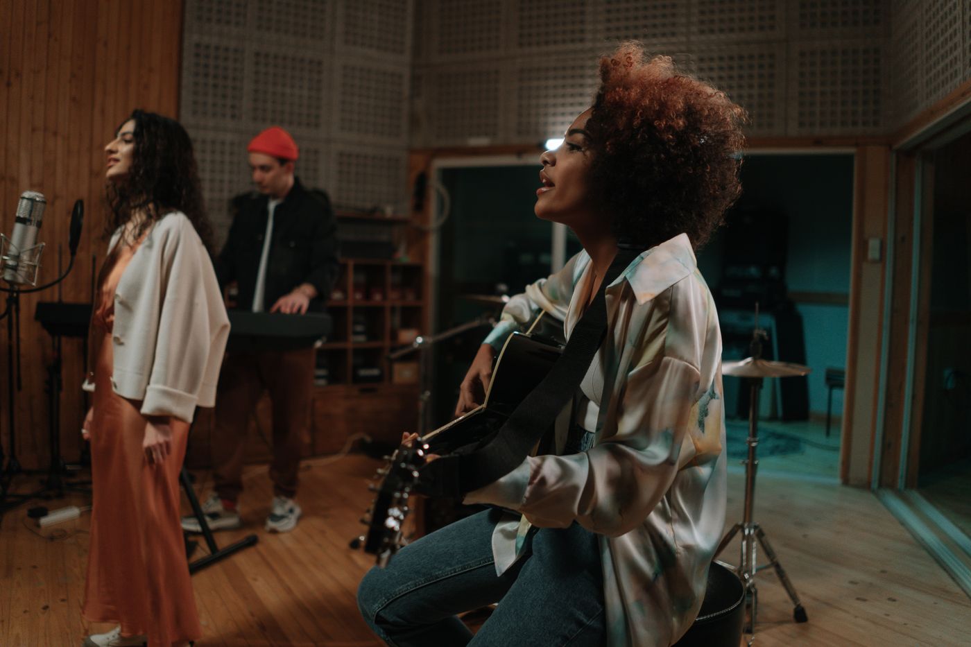 A group of musicians playing together in a music studio