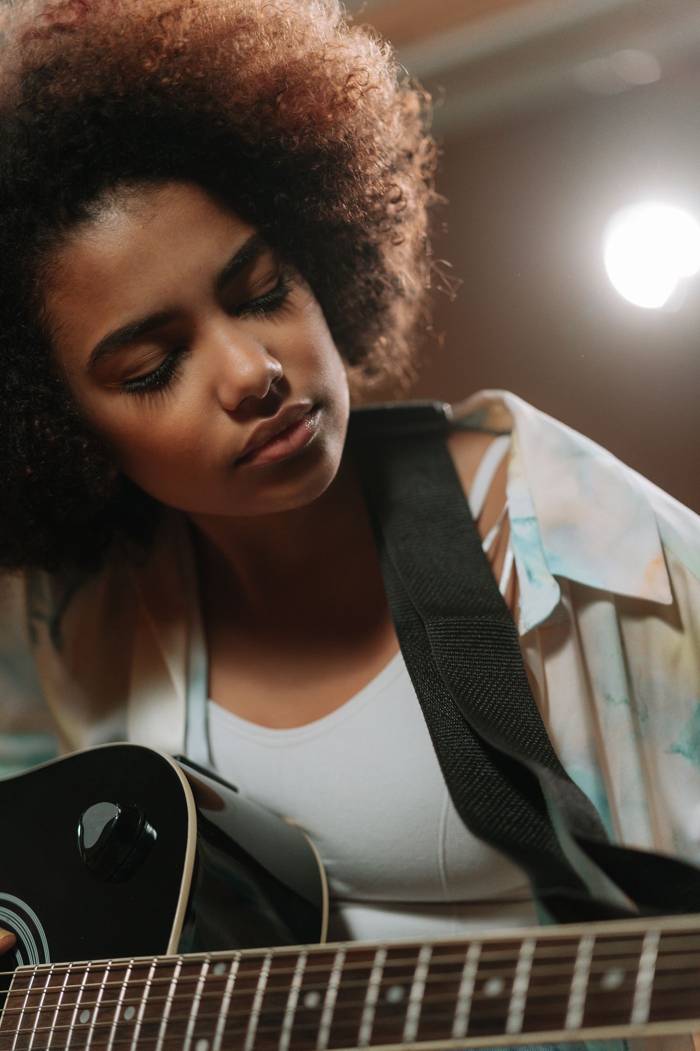 A musician concentrating on an acoustic guitar performance